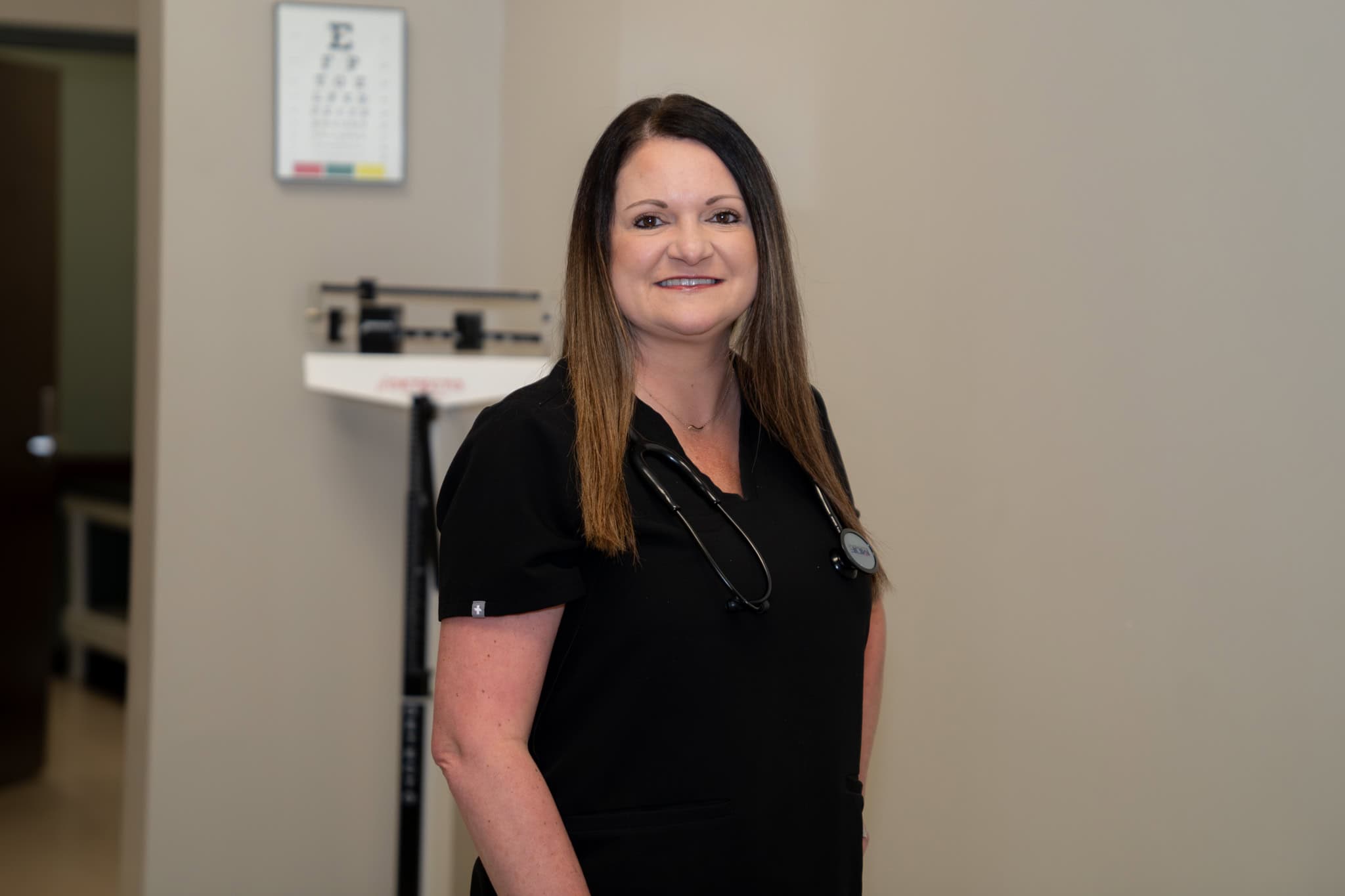 Gulf Coast healthcare professional smiling in clinical setting with stethoscope for medical services and patient care.